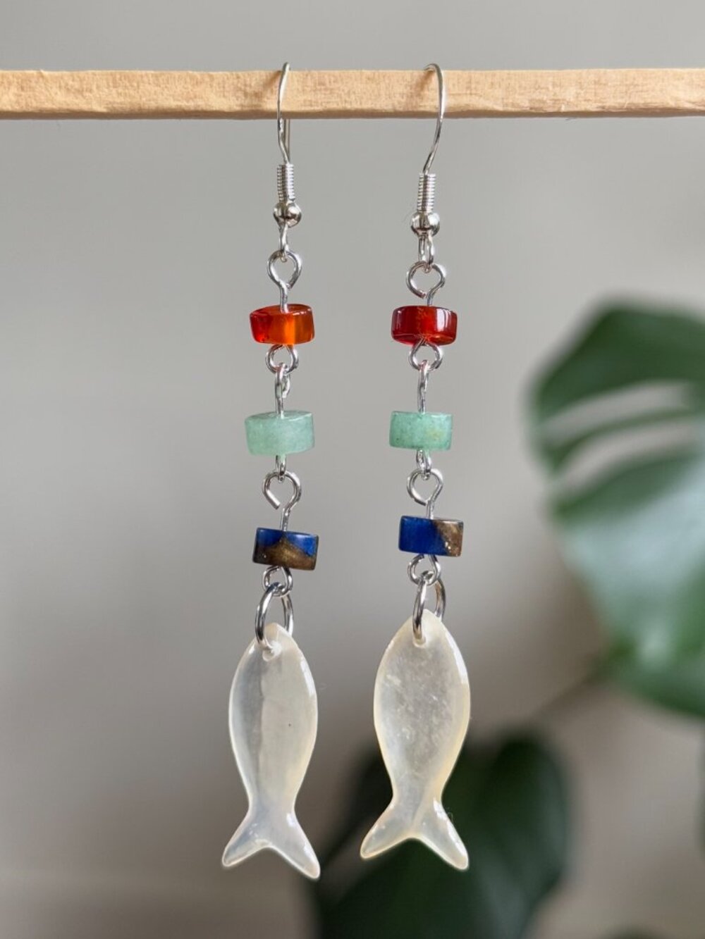 handmade earrings with red green & blue heishi beads and white iridescent fish